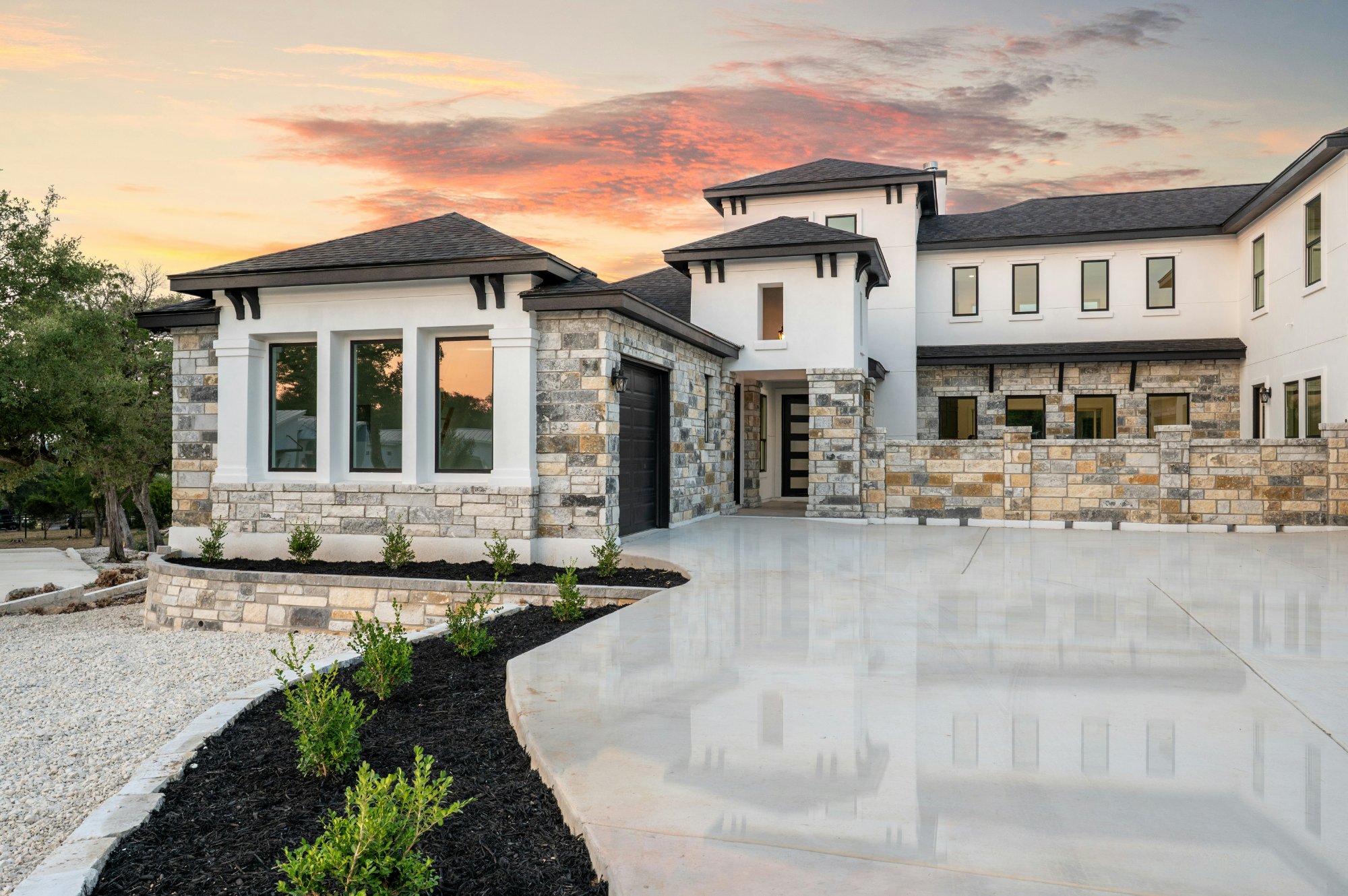 Luxury home exterior stone white sunset